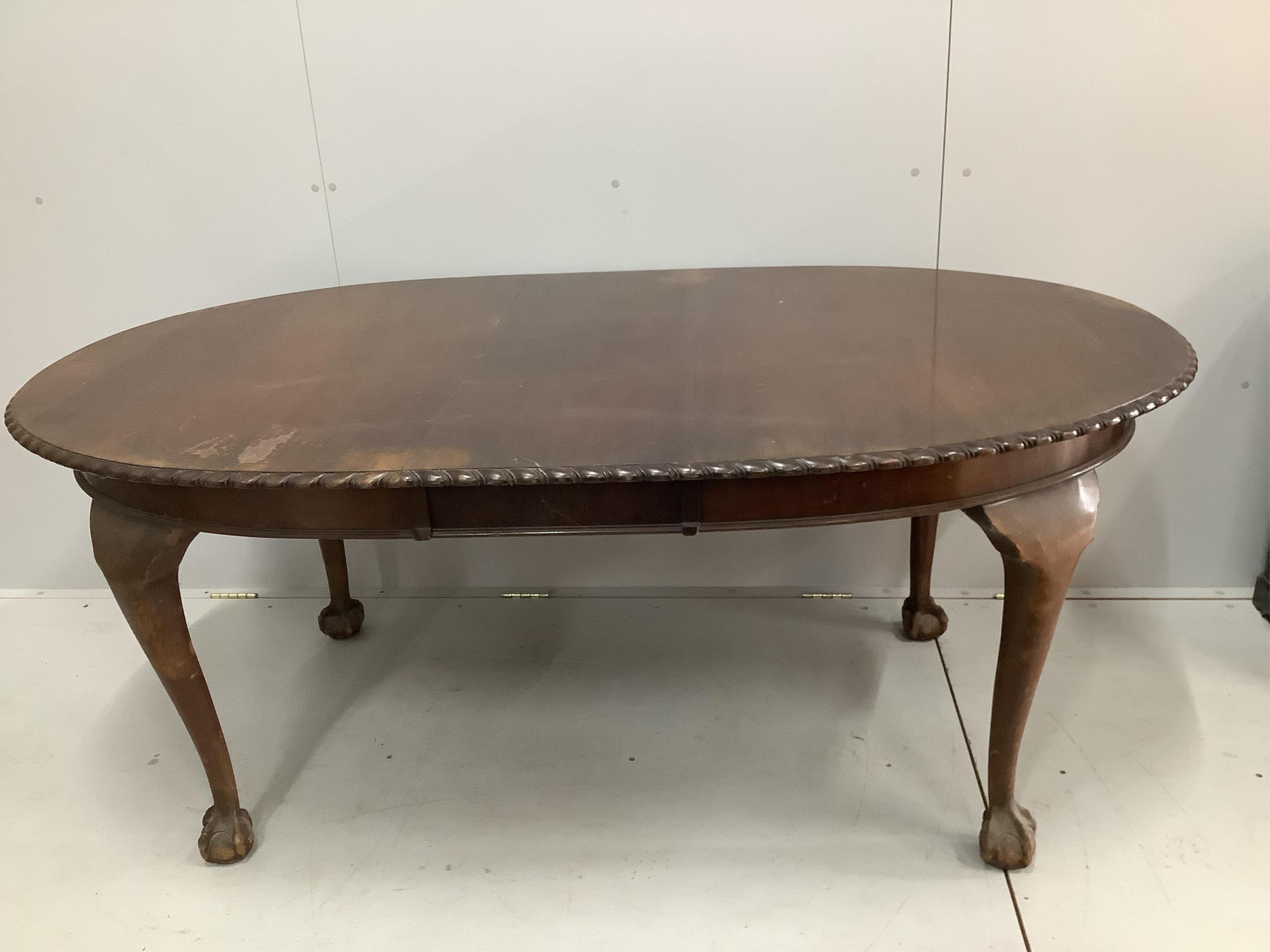 An early 20th century mahogany extending dining table, label for Waring and Gillow. 170cm extended, one spare leaf, depth 106cm, height 72cm. Condition - poor